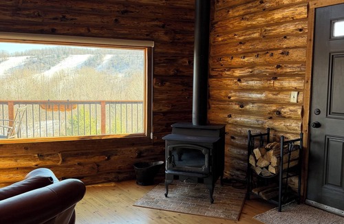 Swain House | Enjoy an updated classic log cabin with ski slope views from the hot tub.