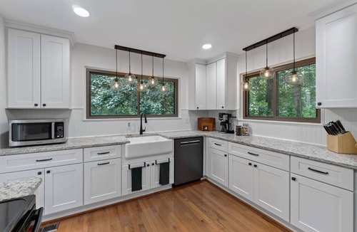 Charlottesville House | Settle into this stylish 4 bedroom, 3.5 bath midterm rental, thoughtfully designed with a warm midcentury modern vibe. Enjoy two primary suites, generous storage, a spacious deck, covered porch and private wooded backyard.