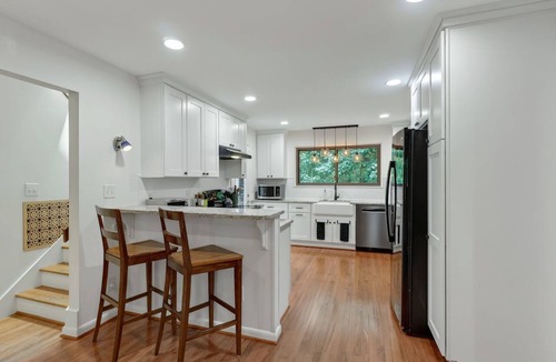 Charlottesville House | Settle into this stylish 4 bedroom, 3.5 bath midterm rental, thoughtfully designed with a warm midcentury modern vibe. Enjoy two primary suites, generous storage, a spacious deck, covered porch and private wooded backyard.