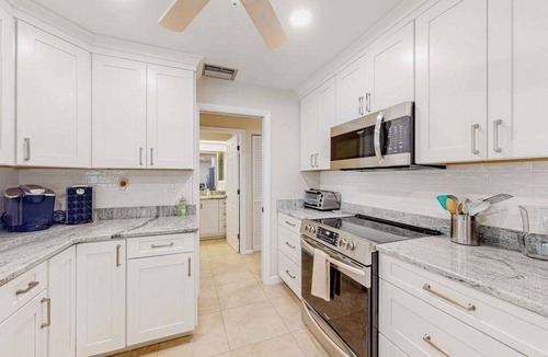 Gulf Cove House | Waterfront home with an enclosed pool, outdoor kitchen, and grill - dog-friendly